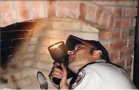 A man holding an electric device in his mouth.