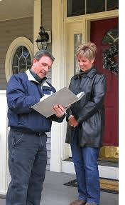 A man and woman looking at a piece of paper.