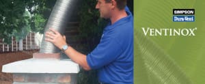 A man in blue shirt working on an air duct.